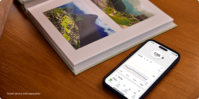 photobook next to a phone showing glucose levels - smart devices sold separately