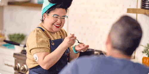 Gina laughing with someone in the kitchen