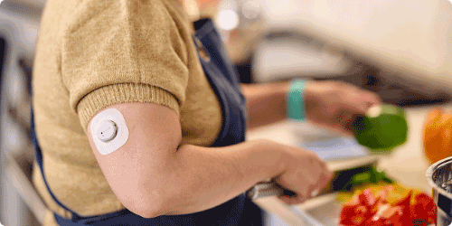 Gina prepping food while wearing the Dexcom sensor