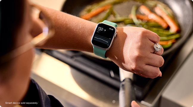 Gina checking her glucose on her smartwatch - smart devices sold separately