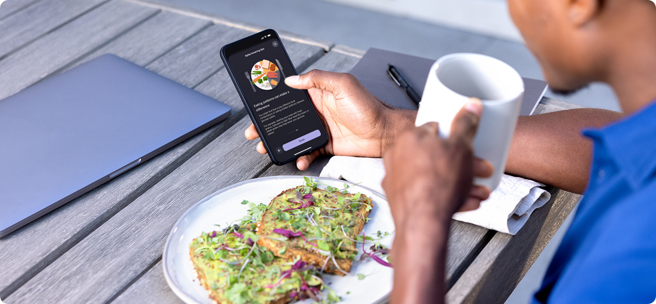 Man drinking coffee while looking at phone